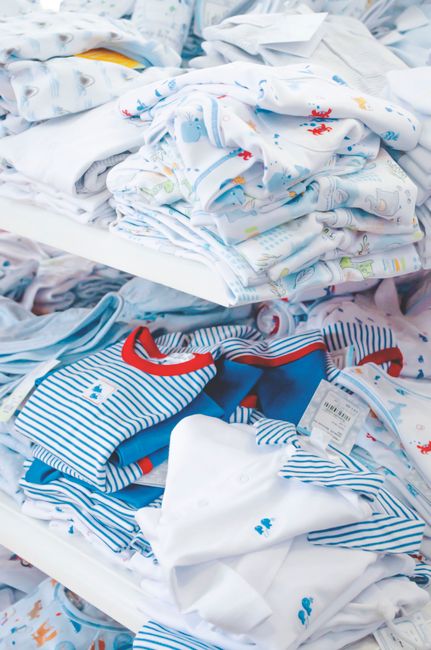 Illustration of various children's product categories: clothing, a children's book, and a bottle with baby powder, symbolizing different Nice Classification classes.